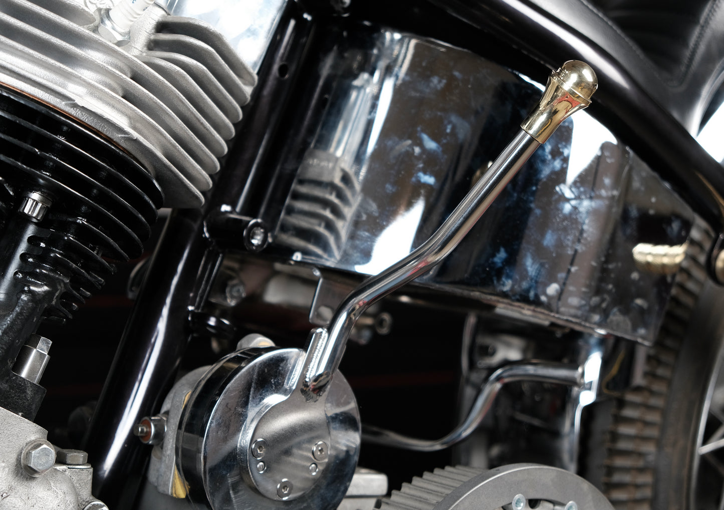 stainless ratchet top jockey shifter with brass handle mounted one a shovel head front view