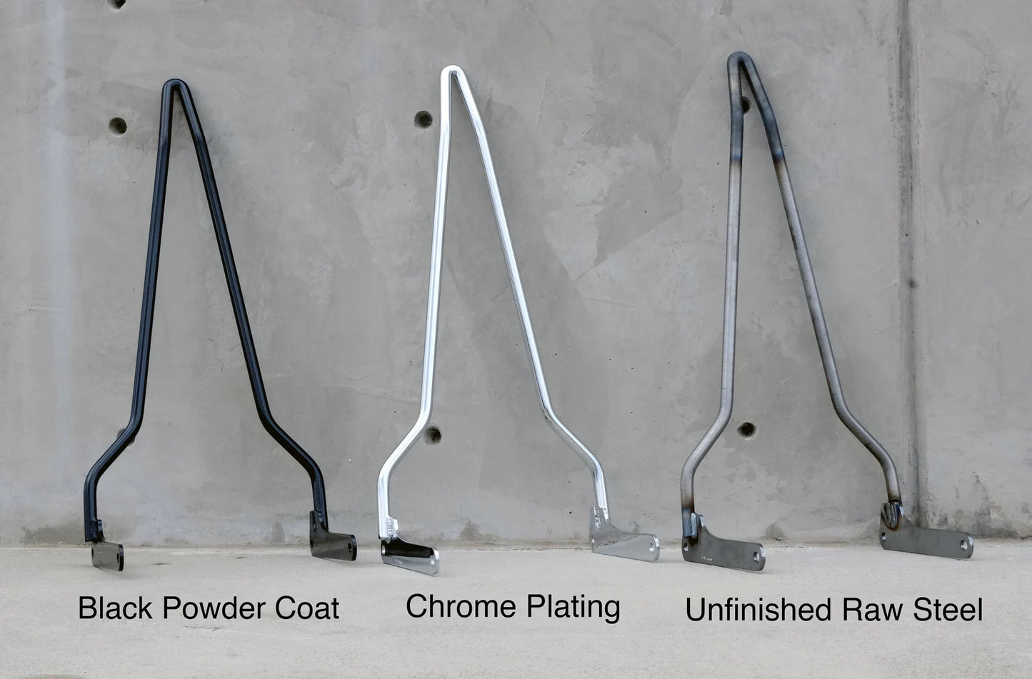 three sissy bar showing black powder coat, chrome, and raw steel finishes